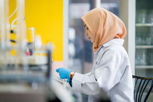 Young woman wearing a hijab working in a research laboratory. Kuala Lumpur, Malaysia