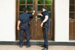 Police officers doing a home investigation searching for evidence